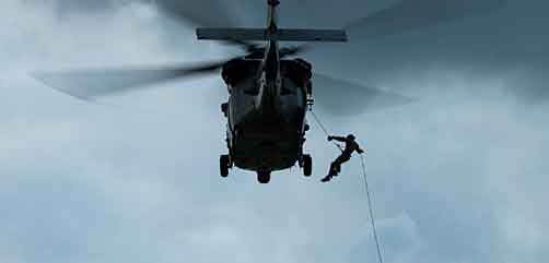 A sailor assigned to Explosive Ordnance Disposal Mobile Unit (EODMU) 5 rappels from an MH-60 Seahawk, belonging to the “Island Knights” of Helicopter Sea Combat Squadron 25 (HSC-25), at Naval Base Guam, August 22, 2017. EODMU 5 conducts mine countermeasures, improvised explosive device operations, renders safe explosive hazards and disarms underwater explosives such as mines. (U.S. Navy Combat Camera photo by Mass Communication Specialist 1st Class Benjamin A. Lewis). - ALLOW IMAGES