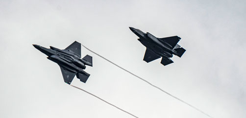Two Air Force F-35 Lightning II aircraft assigned to the 34th Fighter Squadron fly over the 86th Air Base in Romania, Feb. 24, 2022. - ALLOW IMAGES