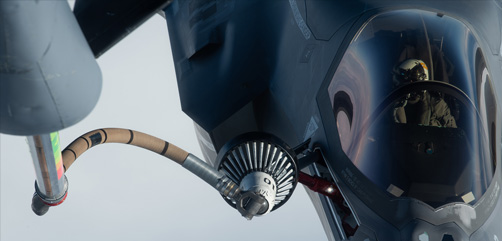 A Marine Corps F-35B Lightning II aircraft receives fuel from a KC-135 Stratotanker during joint refueling training over the Pacific Ocean, Feb. 16, 2022. The drogue-and-probe method of aerial refueling utilizes a trailing hose with a basket on the end, which pilots connect with and receive fuel from via a probe on their aircraft. - ALLOW IMAGES