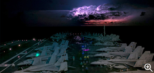 Sailors prepare for flight operations while transiting through a storm aboard the USS Gerald R. Ford in the Atlantic Ocean, Oct. 18, 2022. - ALLOW IMAGES