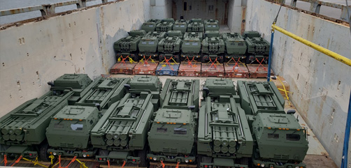 HIMARS systems being offloaded from a transport ship in Romania. - ALLOW IMAGES
