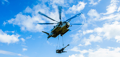 Marines use a helicopter to lift an M777 howitzer at Marine Corps Base Hawaii, Jan. 13, 2022. - ALLOW IMAGES