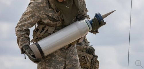 A U.S. Army soldier assigned to 3rd Squadron, 16th Calvary Regiment, carries a M829A4 sabot tank round to load through the hatch of a M1A2 SEP V2 Abrams tank. These and other munitions have been included in the most recent traunch of military support to be sent to Ukraine. Image: DoD - ALLOW IMAGES