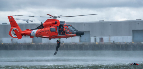 A Coast Guard MH-65 Dolphin helicopter crew conducts a search and rescue demonstration in Charleston, S.C., Feb. 19, 2020. - ALLOW IMAGES