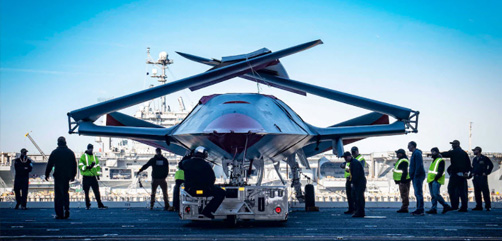 Sailors and Boeing team members prepare to move an unmanned MQ-25 Stingray aircraft into the hangar bay of the aircraft carrier USS George H.W. Bush in Norfolk, Va., Nov. 30, 2021. The MQ-25 will be the world’s first operational, carrier-based unmanned aircraft. - ALLOW IMAGES