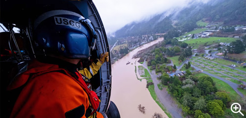 Coast Guard Petty Officer 3rd Class Clayton Maidlow surveys a flooded region of the Russian River during an overflight mission in California, Jan. 11, 2023. Coast Guard aircrews deployed to the San francisco Bay Area from across the west coast in response to recent flooding. - ALLOW IMAGES. 