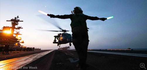 A sailor assigned to Helicopter Sea Combat Squadron 5 signals the landing of an MH-60S Sea Hawk aboard the aircraft carrier USS George H.W. Bush in the U.S. Central Command area of operations, May 13, 2026. - ALLOW IMAGES.