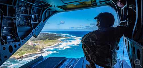 Army Sgt. Shelby Lewis looks out of the rear of a CH-47 Chinook during training over Hawaii, March 3, 2024. Image: DoD - ALLOW IMAGES