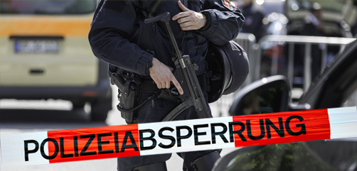 A German police officer handles an automatic weapon as car searches are carried out.  -  ALLOW IMAGES