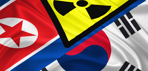 North and South Korean flags overlaid with a radiation symbol. - ALLOW IMAGES