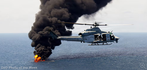 A Marine Corps UH-1Y Venom helicopter flies over a vessel of interest being destroyed — after being boarded and cleared — during a maritime interdiction operation in the U.S. Southern Command area of responsibility in the Pacific Ocean, Sept. 5, 2026. - ALLOW IMAGES.