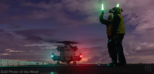 Sailors assigned to the USS Somerset signal a CH-53E Super Stallion helicopter during night deck landing qualifications as part of Quarterly Underway Amphibious Readiness Training 25.2 while underway in the Pacific Ocean, March 12, 2025.  Image: DoD - ALLOW IMAGES
