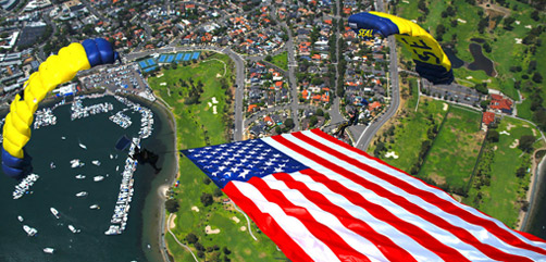 Members of the Navy Parachute Team, the Leap Frogs, perform a tethered flag with smoke brackets during a demonstration in San Diego, July 4, 2020. - ALLOW IMAGES