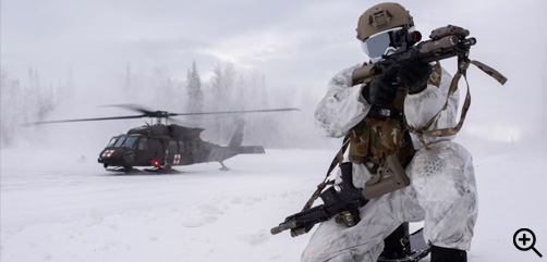 A special tactics airman provides security while an Alaska Army National Guard Black Hawk helicopter lands behind him during an arctic training exercise at Camp Mad Bull, Joint Base Elmendorf-Richardson, Alaska, Jan. 10, 2023. - ALLOW IMAGES. 
