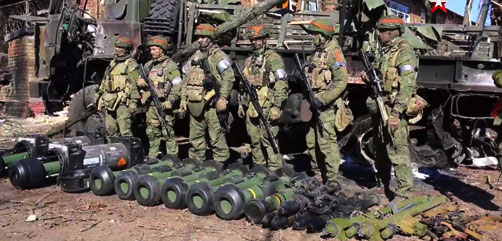Russian soldiers (note the ribbon of Saint George helmet bands) standing above captured western weapons including Javalin  and other anti-tank and air missiles. Thus us war...  - ALLOW IMAGES