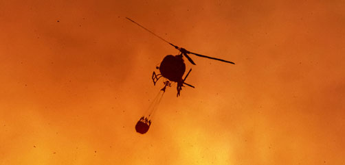 Helicopter prepares for water drop on a California wilfire.- ALLOW IMAGES
