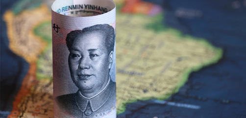 Closeup of Chinese currency atop a map of S. America. Image: DepositPhotos.com - ALLOW IMAGES