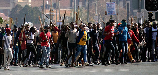Supporters of former president Jacob Zuma march through the streets during clashes in downtown Johannesburg. - ALLOW IMAGES